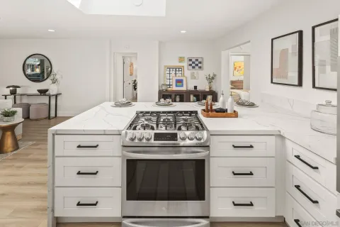a white stove top oven sitting inside of a kitchen