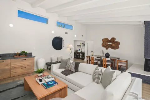 a living room with furniture and a mirror