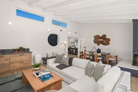 a living room with furniture and a mirror