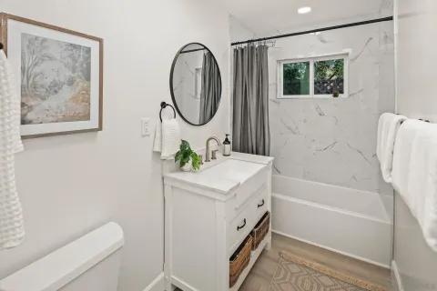 a bathroom with a sink a toilet and a bathtub