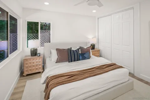 a bedroom with a bed and a mirror