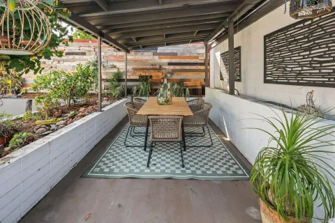 a view of a house with backyard and sitting area