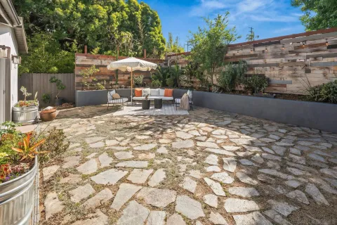 a backyard of a house with table and chairs