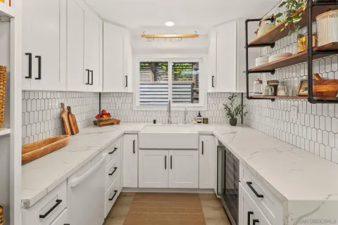 a kitchen that has a sink and a stove in it