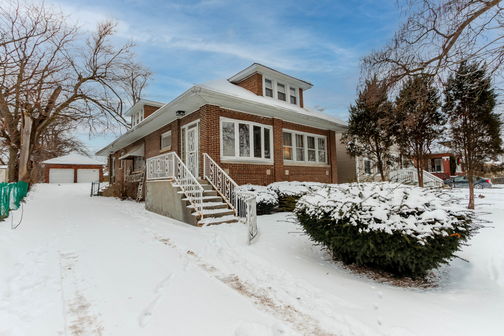 10152 South Winston Avenue Chicago, IL 60643 - Photo 2 of 2 a front view of a house with a yard covered in snow