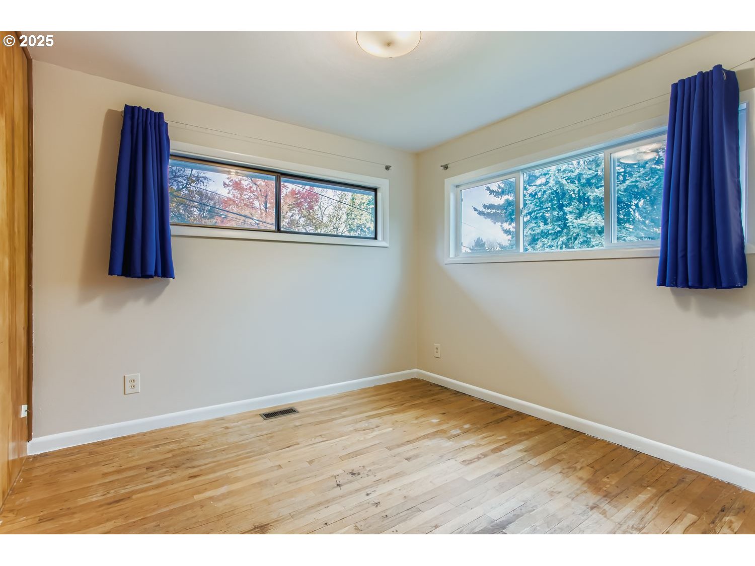 6405 Southwest Radcliff Street Portland, OR 97219 - Photo 15 of 26 an empty room with wooden floor and a window
