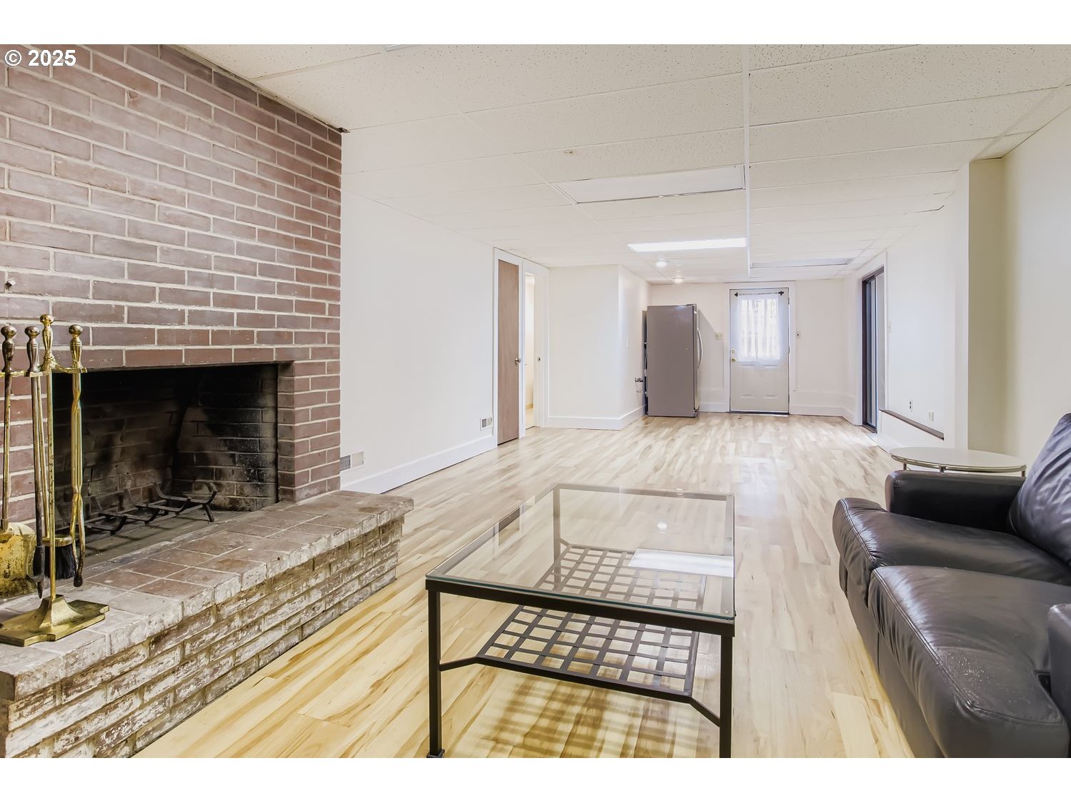 6405 Southwest Radcliff Street Portland, OR 97219 - Photo 16 of 26 a living room with furniture and a fireplace