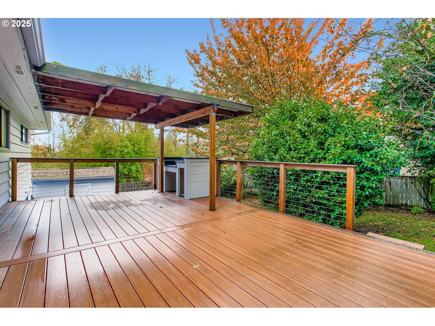 6405 Southwest Radcliff Street Portland, OR 97219 - Photo 22 of 26 a view of backyard with a deck and wooden floor