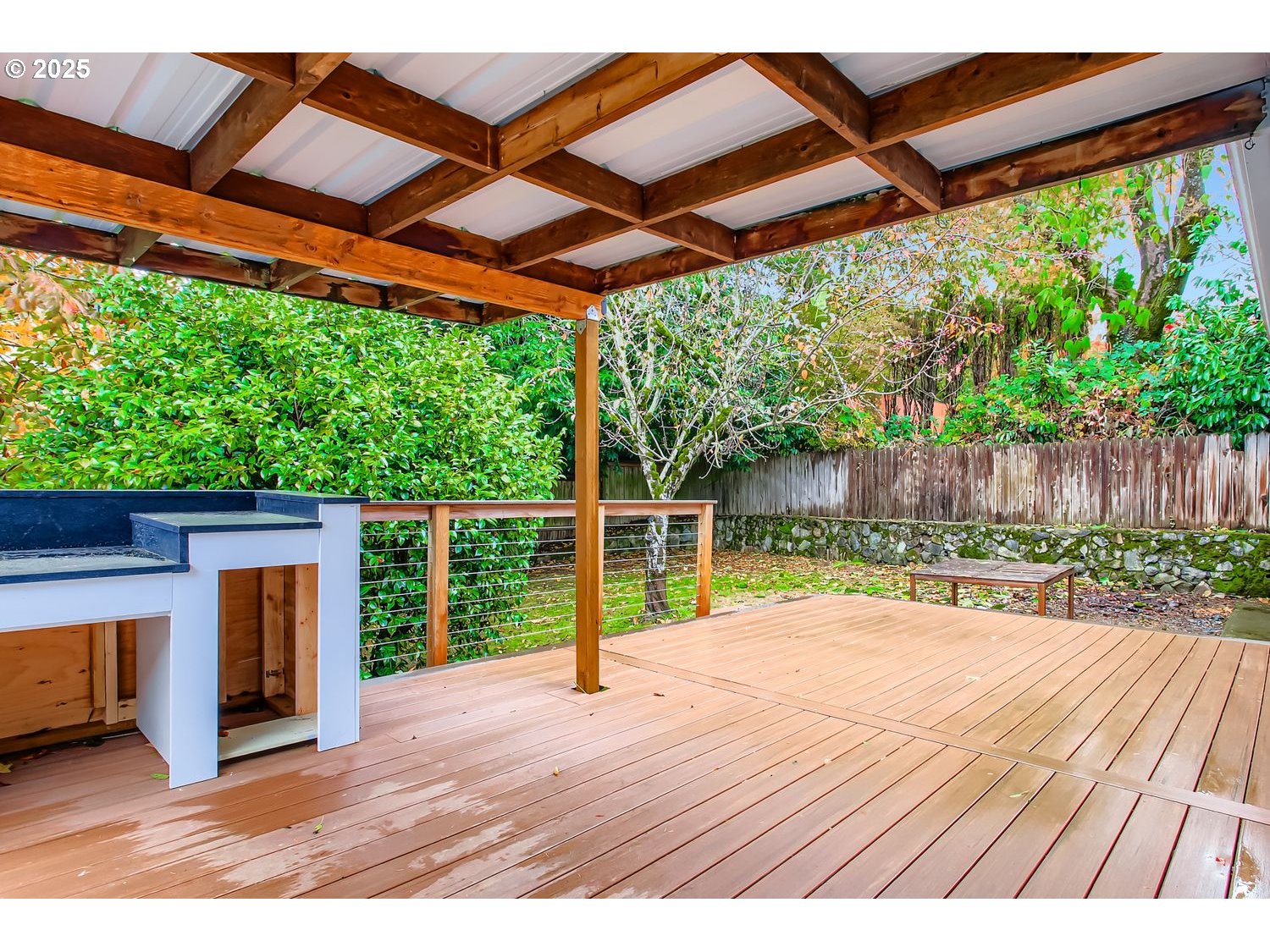 6405 Southwest Radcliff Street Portland, OR 97219 - Photo 23 of 26 a backyard of a house with wooden floor and outdoor space