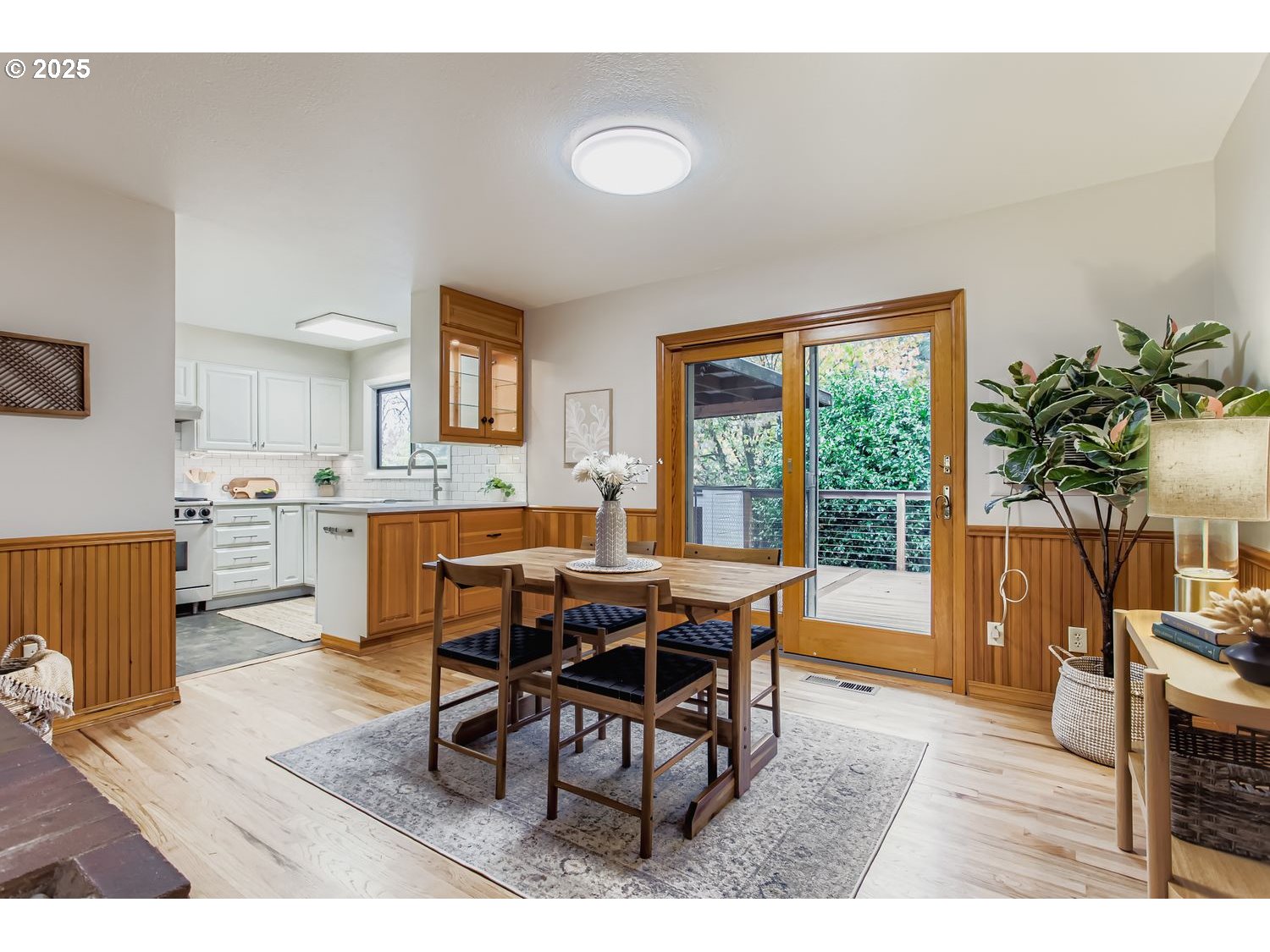6405 Southwest Radcliff Street Portland, OR 97219 - Photo 5 of 26 a view of a dining room with furniture and a potted plant