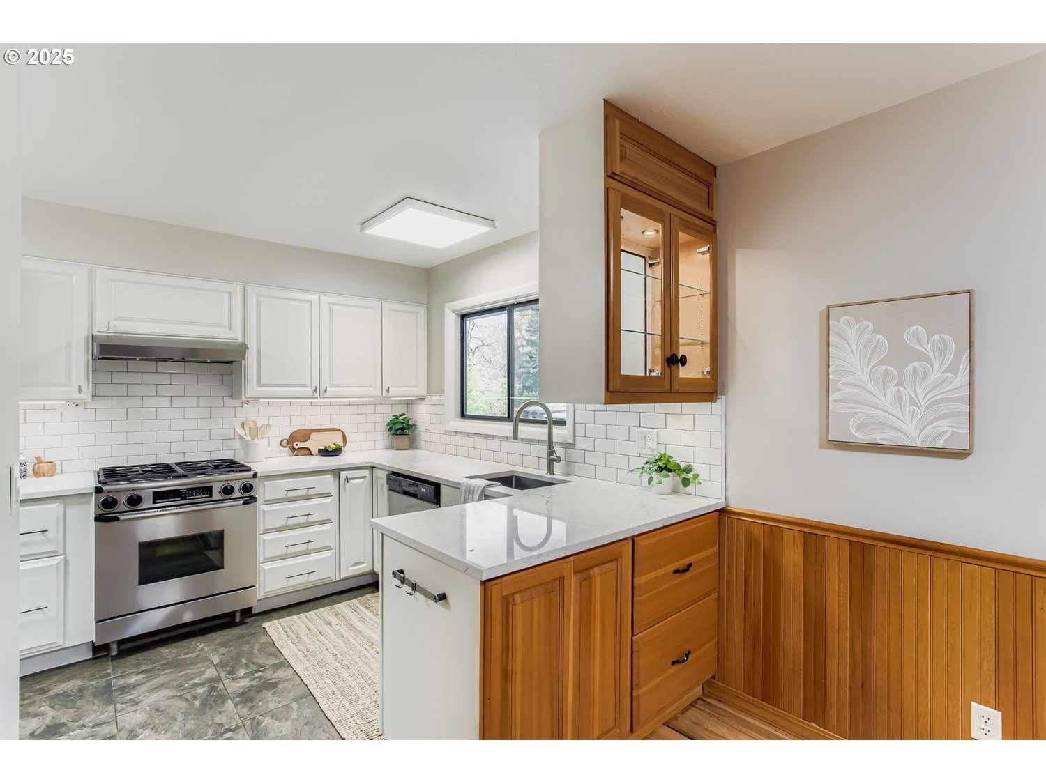 6405 Southwest Radcliff Street Portland, OR 97219 - Photo 7 of 26 a kitchen with a stove a sink and a microwave