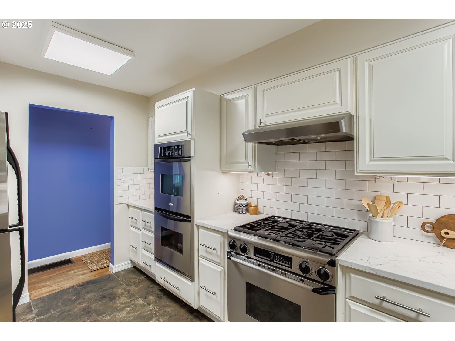 6405 Southwest Radcliff Street Portland, OR 97219 - Photo 9 of 26 a kitchen with stainless steel appliances granite countertop a stove and a refrigerator