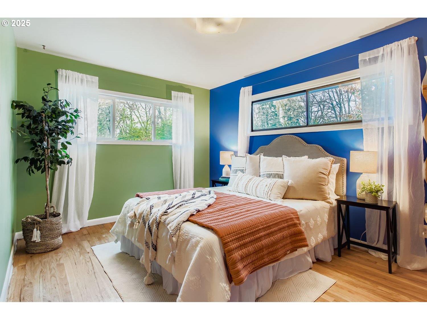 6405 Southwest Radcliff Street Portland, OR 97219 - Photo 10 of 26 a bedroom with a bed a mirror and a potted plant