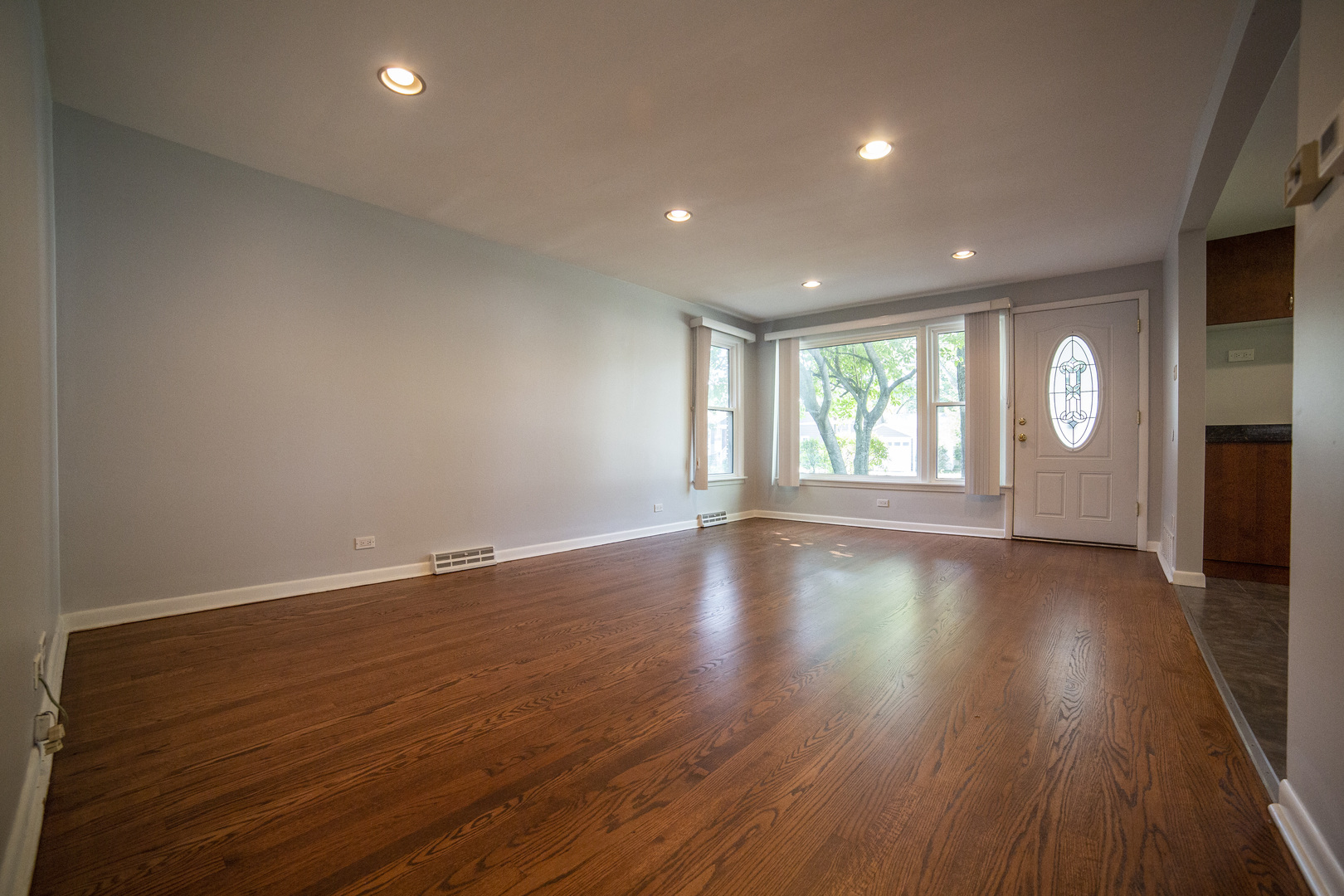 1222 Hickory Road Homewood, IL 60430 - Photo 2 of 29 an empty room with wooden floor and windows