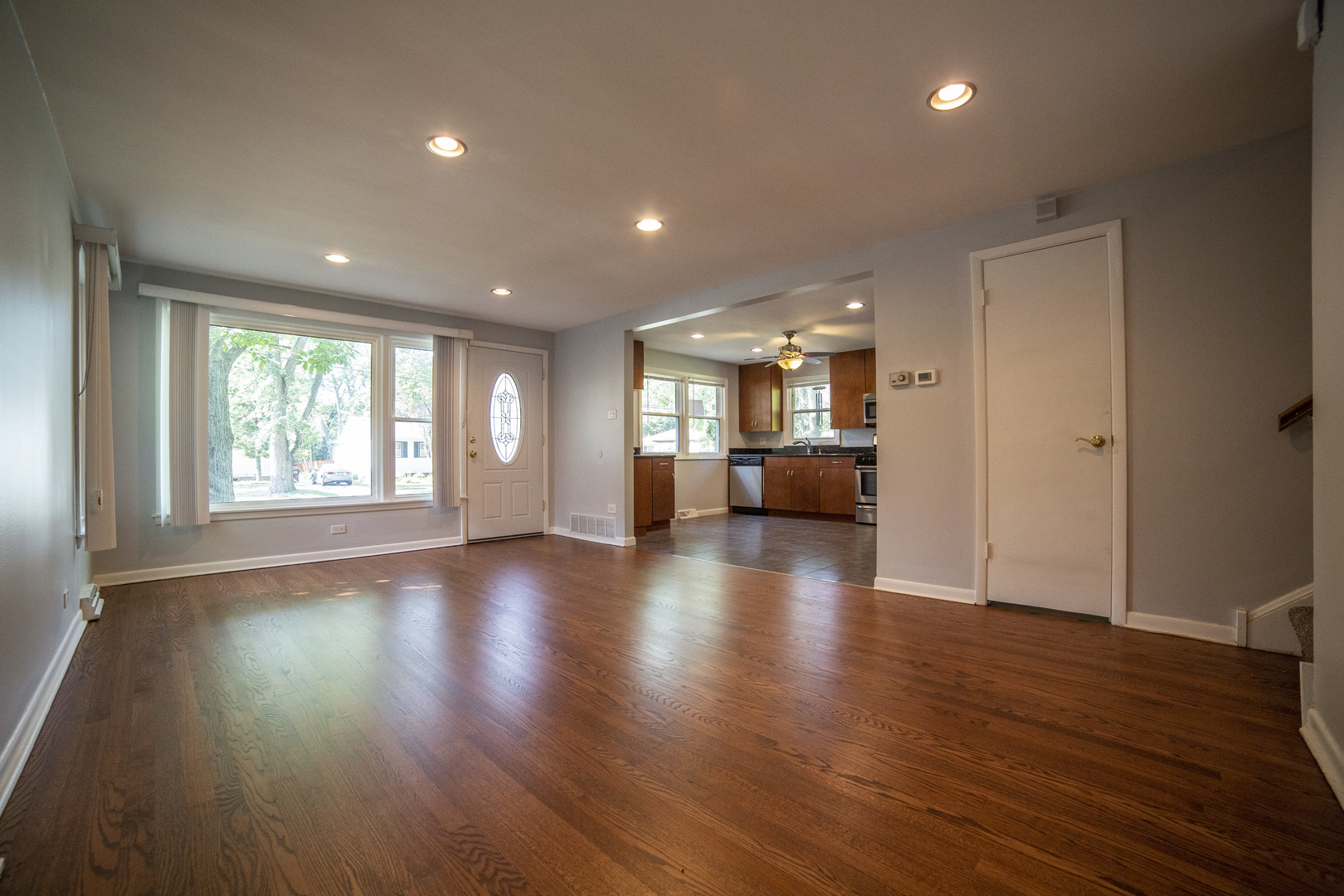 1222 Hickory Road Homewood, IL 60430 - Photo 3 of 29 an empty room with wooden floor and windows