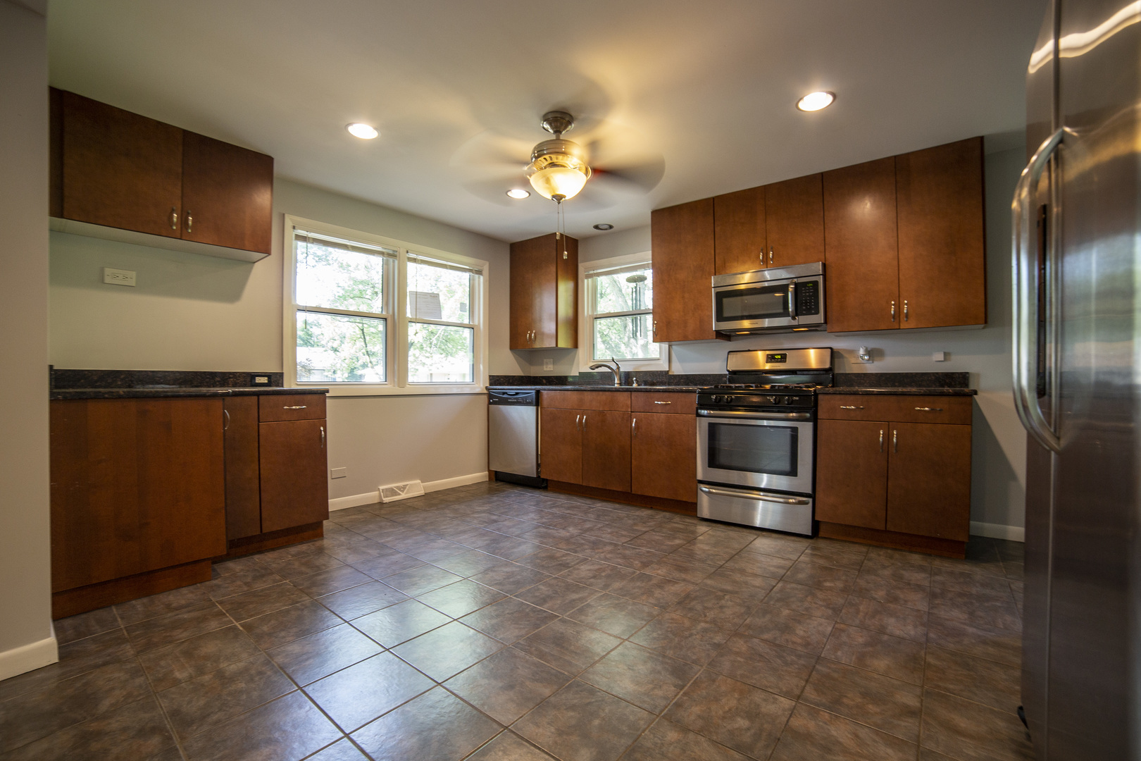 1222 Hickory Road Homewood, IL 60430 - Photo 5 of 29 a kitchen with stainless steel appliances kitchen island granite countertop a stove cabinets and sink