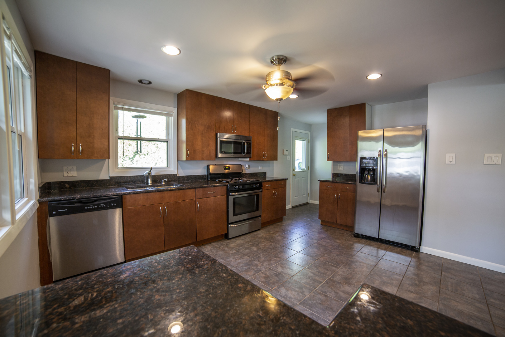 1222 Hickory Road Homewood, IL 60430 - Photo 6 of 29 a kitchen with granite countertop stainless steel appliances and wooden cabinets