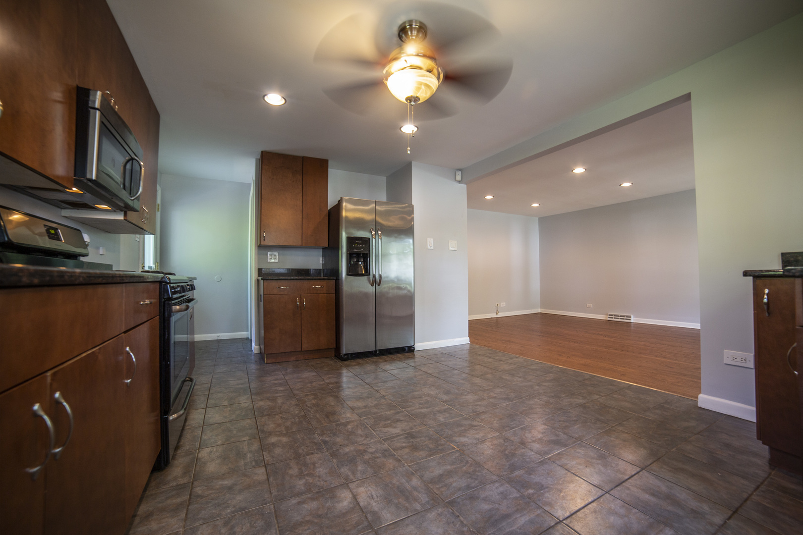 1222 Hickory Road Homewood, IL 60430 - Photo 7 of 29 a kitchen with stainless steel appliances granite countertop a refrigerator and a stove top oven