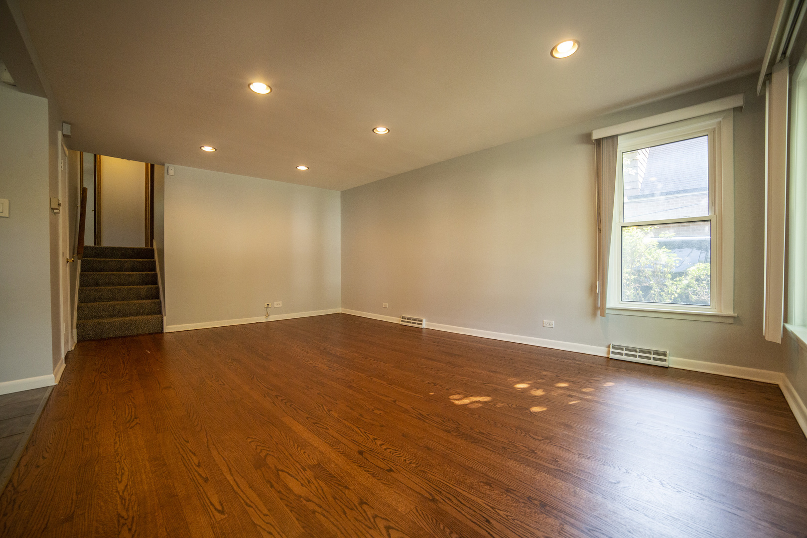 1222 Hickory Road Homewood, IL 60430 - Photo 9 of 29 an empty room with wooden floor and windows