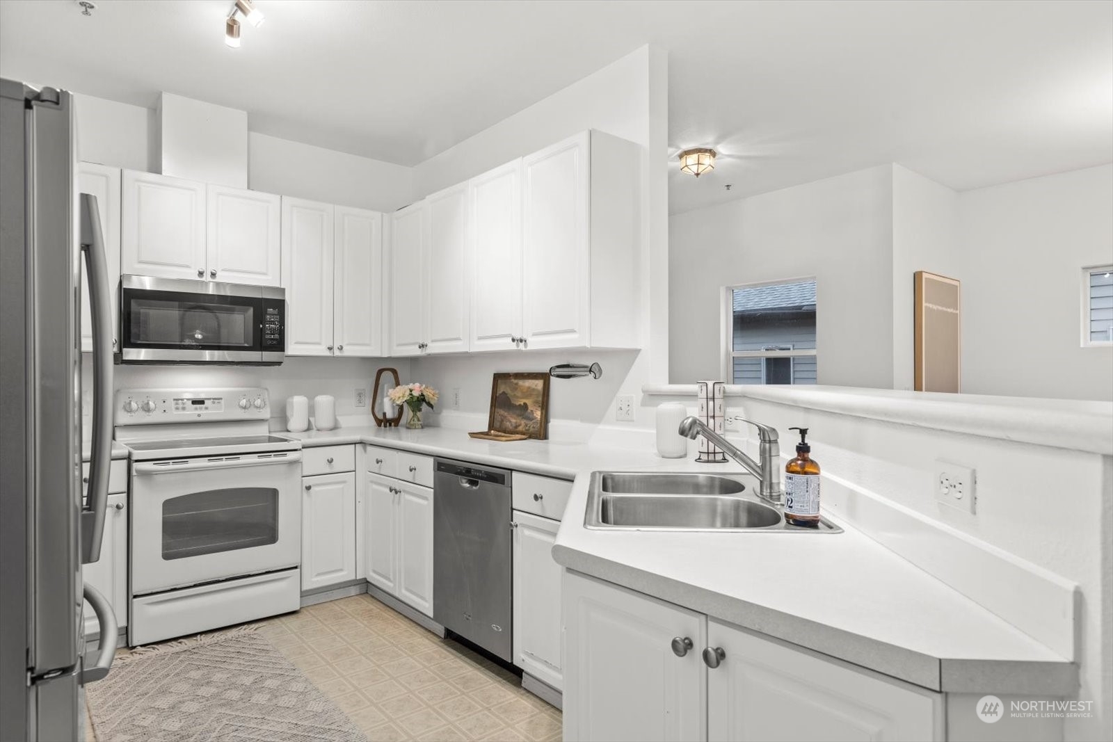 17757 134th Lane Southeast Renton, WA 98058 - Photo 14 of 38 a kitchen with cabinets a sink and appliances