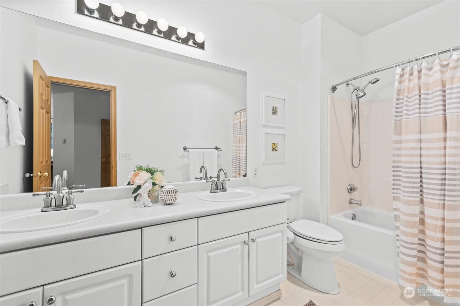 17757 134th Lane Southeast Renton, WA 98058 - Photo 23 of 38 a bathroom with a double vanity sink toilet mirror and shower