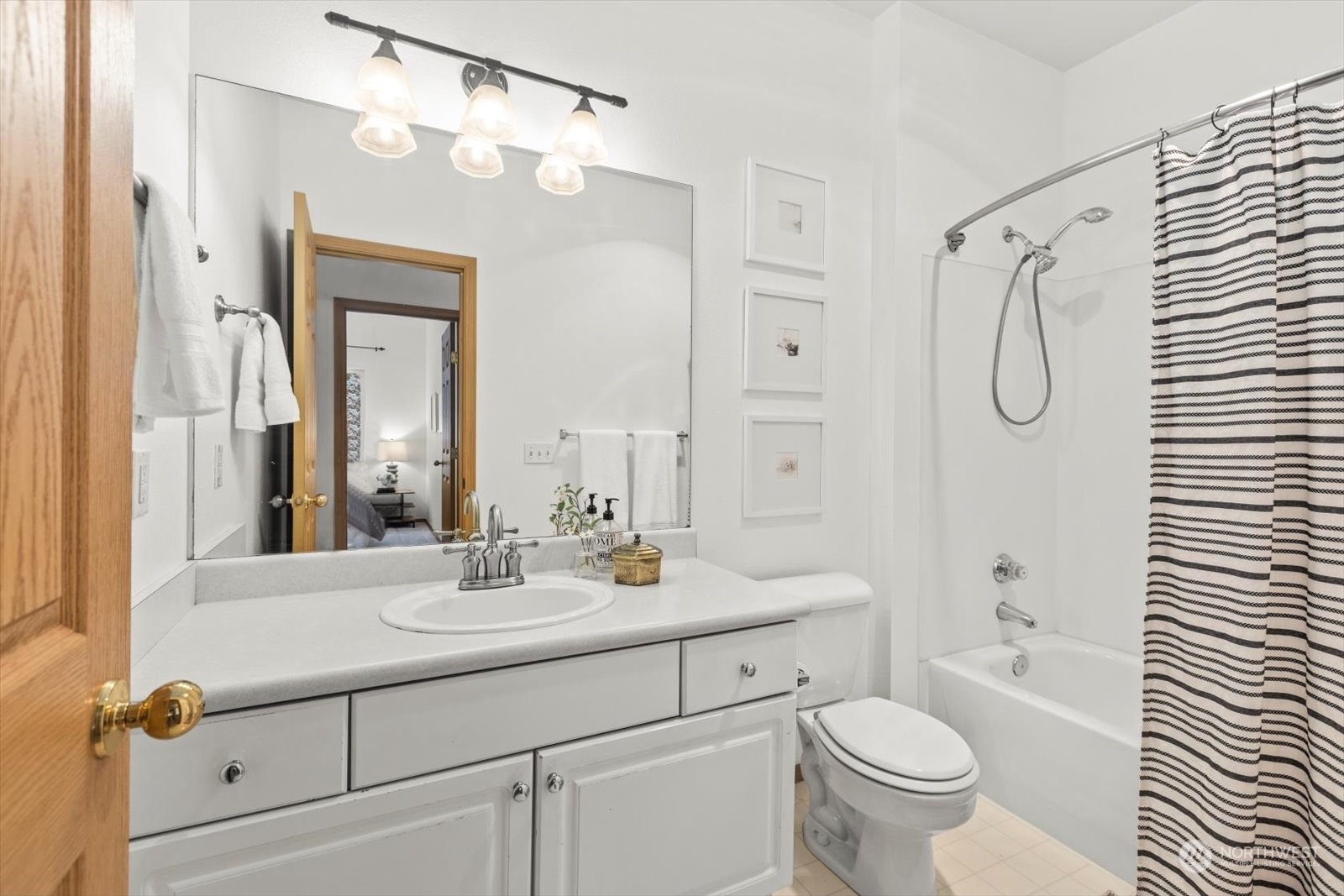 17757 134th Lane Southeast Renton, WA 98058 - Photo 28 of 38 a bathroom with a sink toilet a mirror and shower