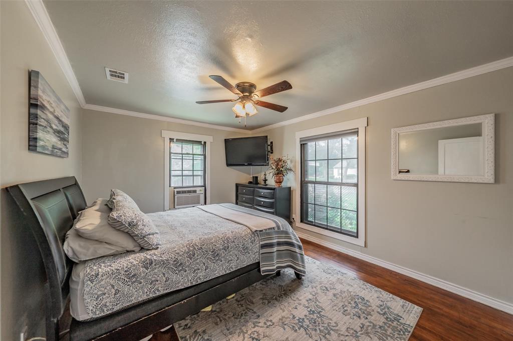 1802 Keneipp Road Carrollton, TX 75006 - Photo 8 of 22 This bedroom features hardwood floors, a ceiling fan, and crown molding