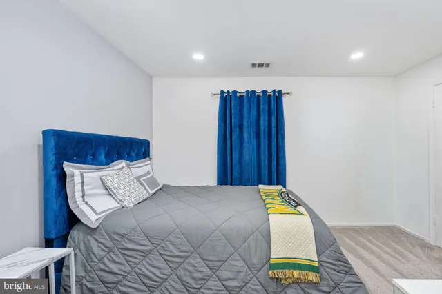 a bedroom with a bed and a dresser