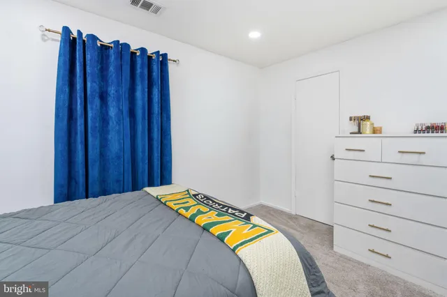 a bedroom with a bed and cabinet