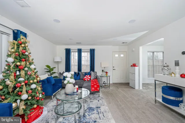 a living room with furniture and flowers