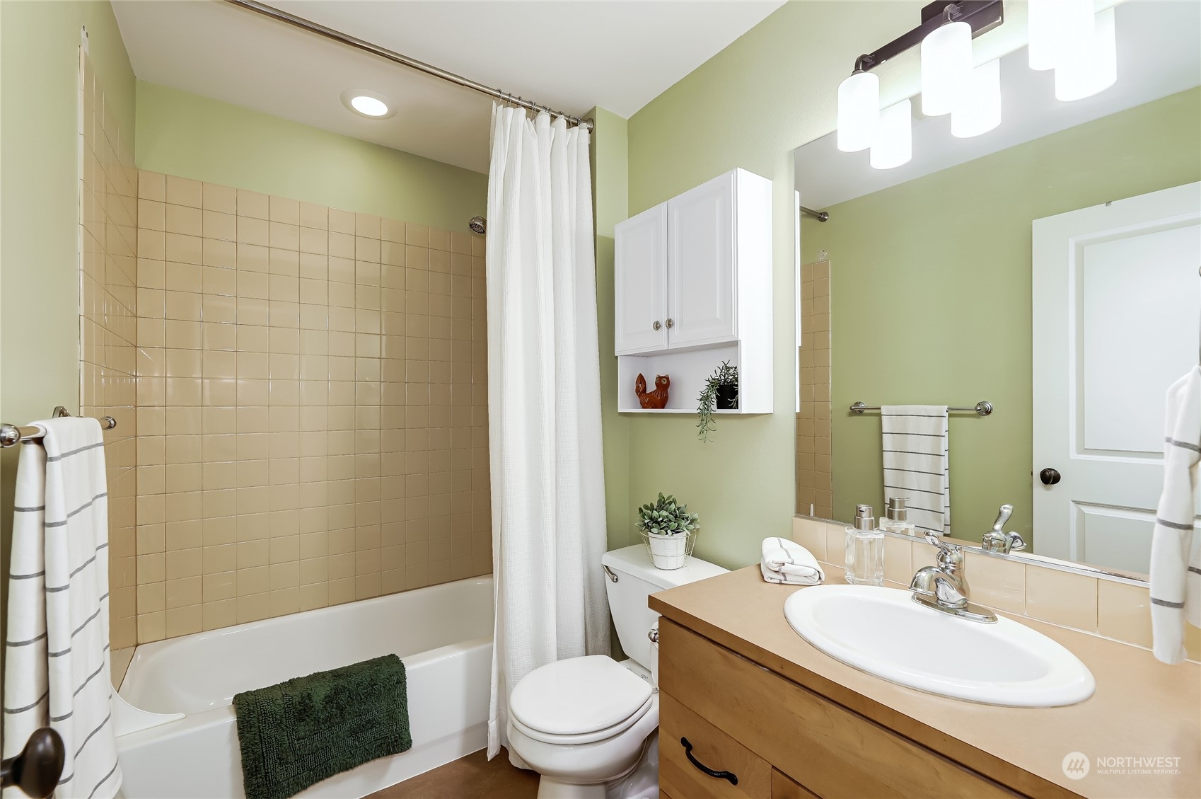 3117 Southwest Raymond Street Seattle, WA 98126 - Photo 21 of 36 a bathroom with a granite countertop sink a toilet a mirror and shower