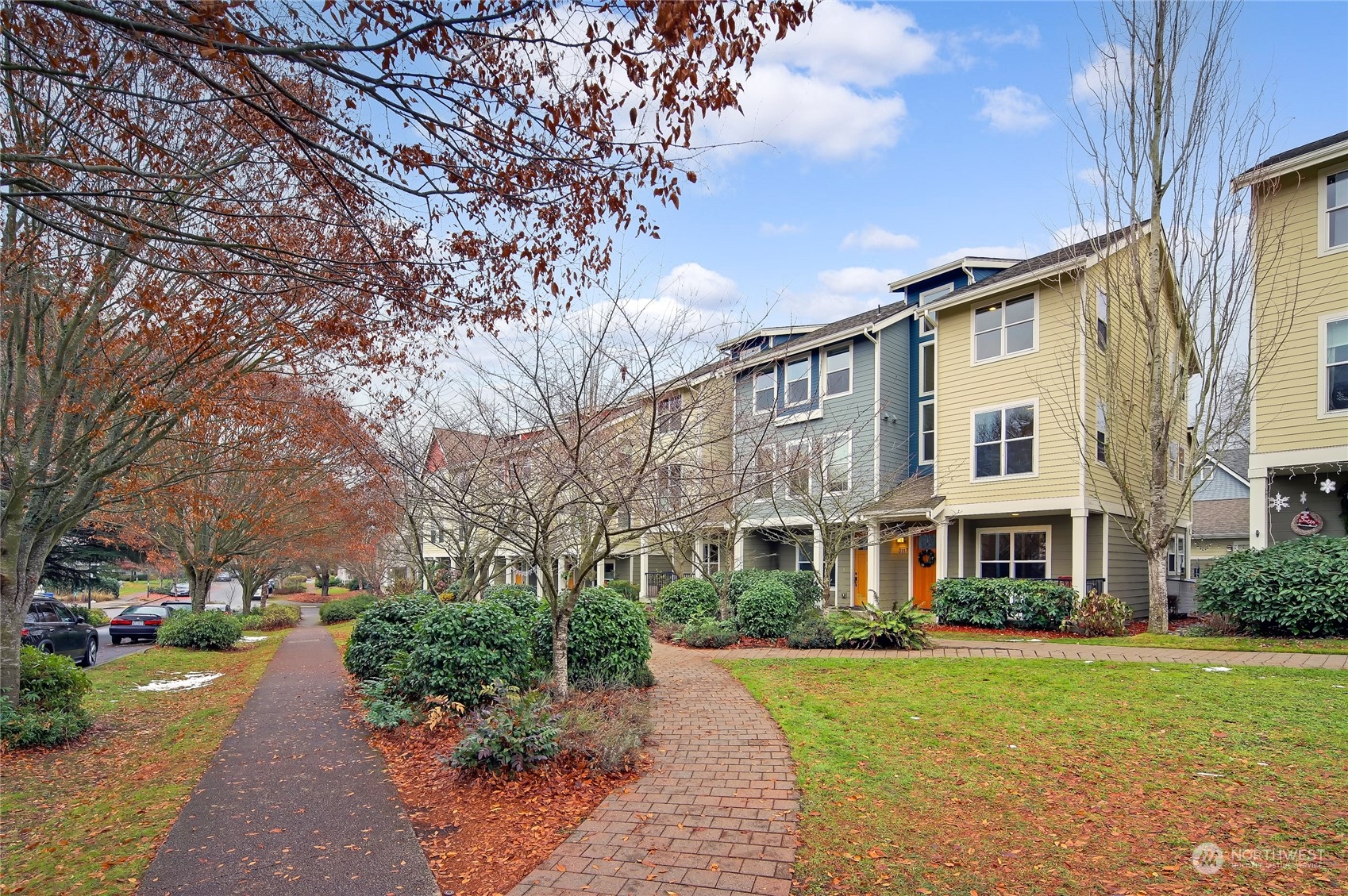 3117 Southwest Raymond Street Seattle, WA 98126 - Photo 27 of 36 a front view of a residential apartment building with a yard