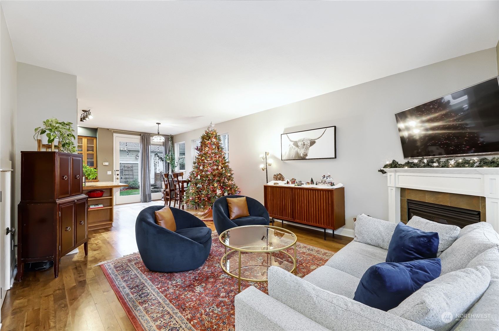 3117 Southwest Raymond Street Seattle, WA 98126 - Photo 3 of 36 a living room with furniture a flat screen tv and a fireplace
