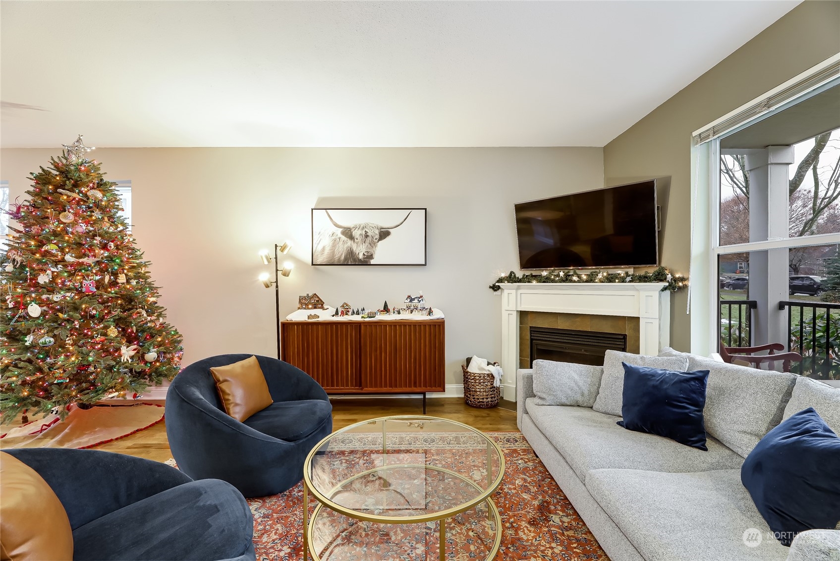3117 Southwest Raymond Street Seattle, WA 98126 - Photo 4 of 36 a living room with furniture a flat screen tv and a fireplace