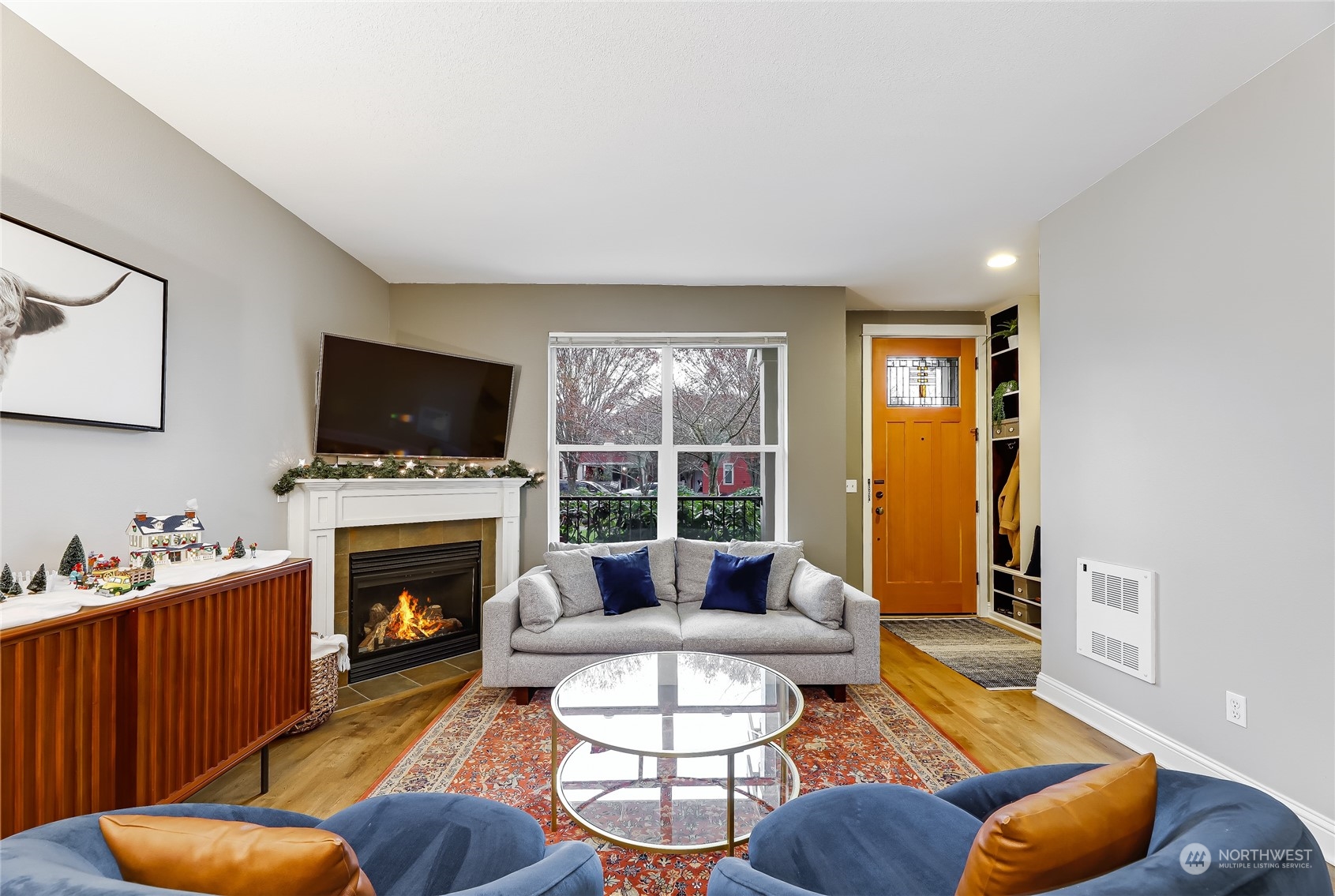 3117 Southwest Raymond Street Seattle, WA 98126 - Photo 5 of 36 a living room with furniture a fireplace and a flat screen tv