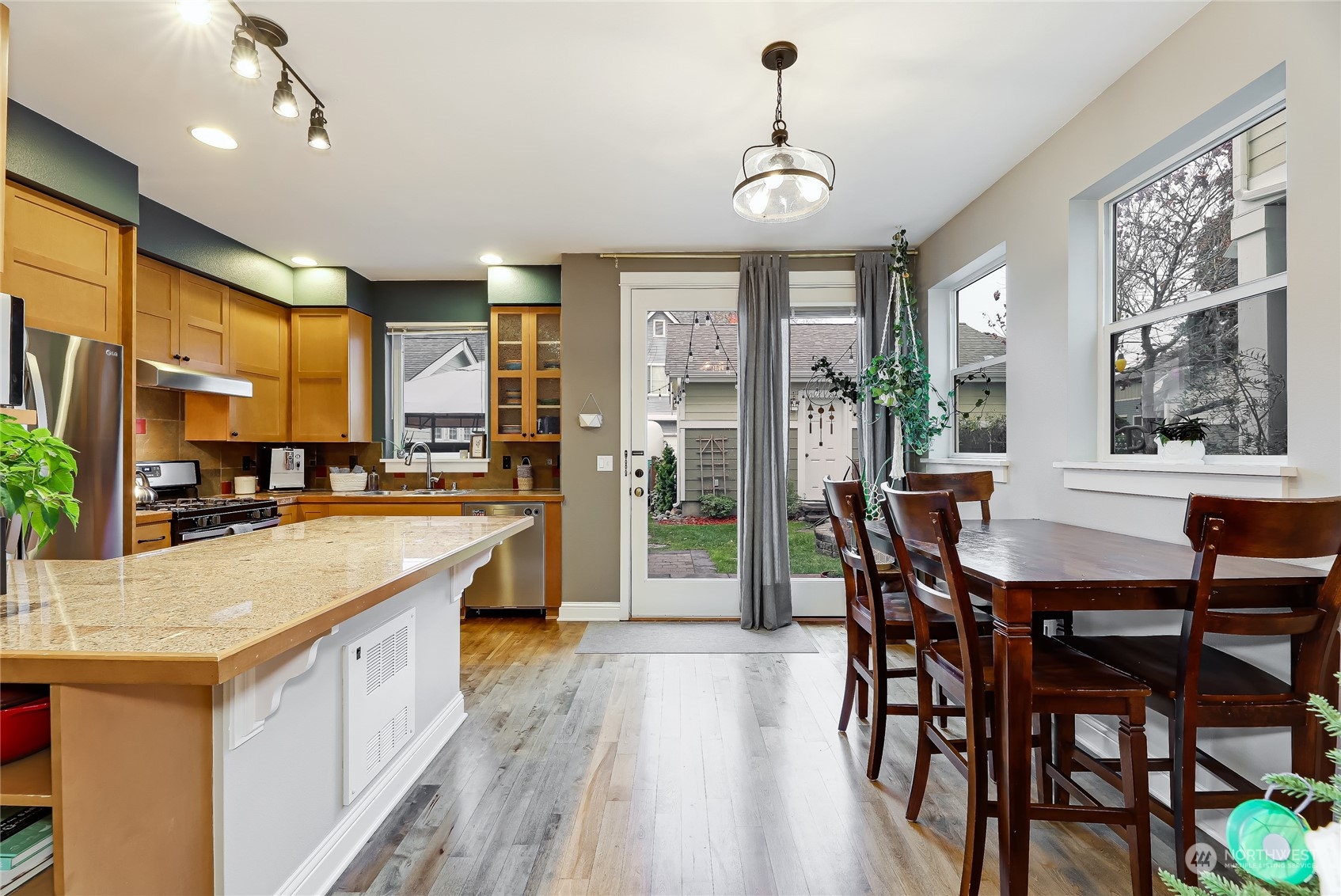 3117 Southwest Raymond Street Seattle, WA 98126 - Photo 7 of 36 a open kitchen with stainless steel appliances granite countertop a stove and refrigerator
