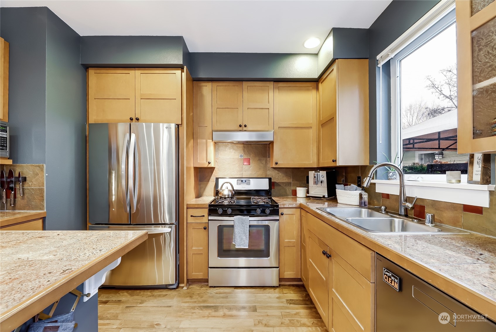 3117 Southwest Raymond Street Seattle, WA 98126 - Photo 8 of 36 a kitchen with stainless steel appliances granite countertop a sink stove and refrigerator