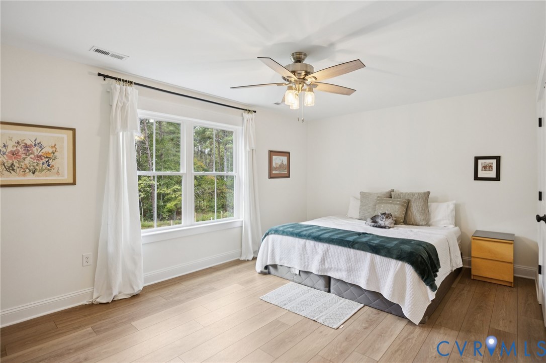 15290 Dunn Road Montpelier, VA 23192 - Photo 13 of 32 Bedroom with ceiling fan and light wood-style floo