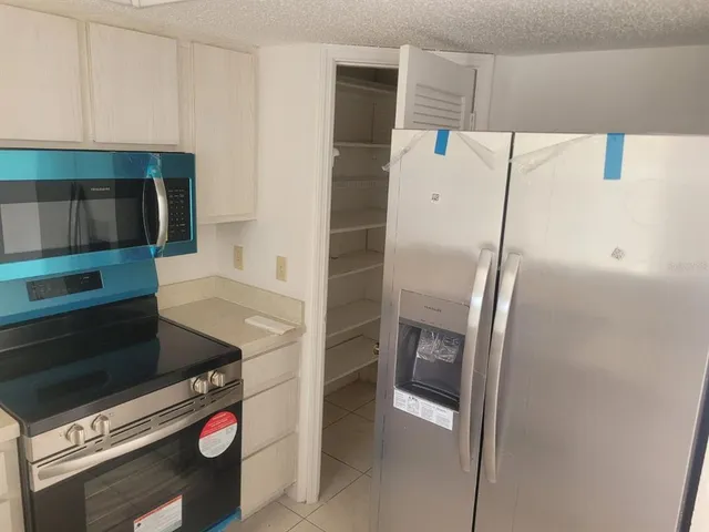 a kitchen with a refrigerator and a stove