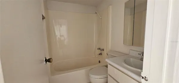 a bath room with a toilet and a bath tub