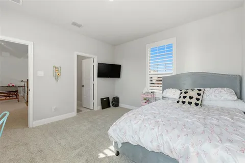 a bedroom with a bed and a television