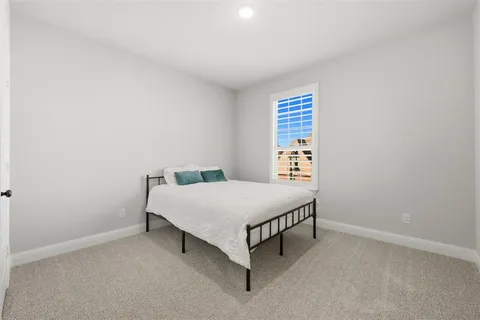 a room with a bed and a window