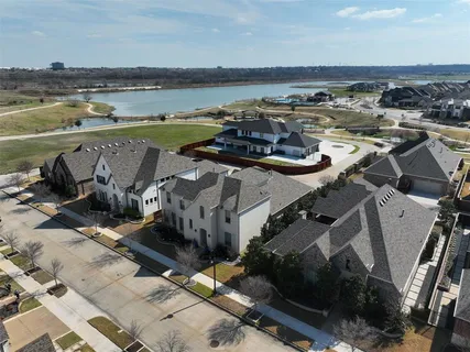 an aerial view of a building with outdoor seating and ocean view
