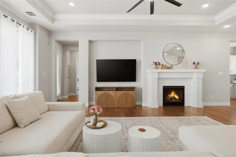 a living room with furniture a flat screen tv and a fireplace