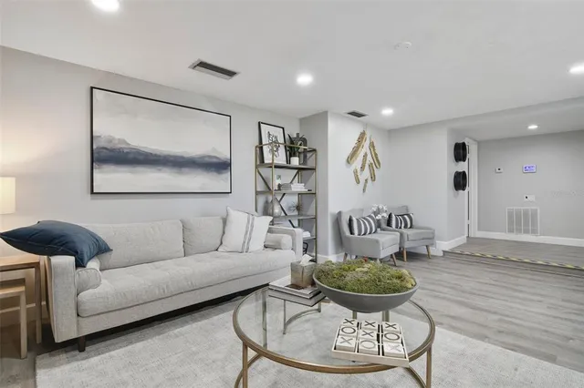 a living room with furniture and a book shelf