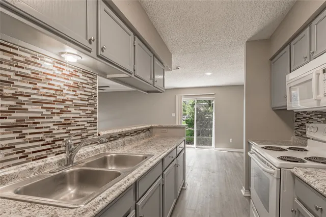 a kitchen with a sink stove and cabinets