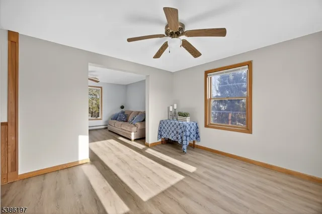 a living room with a bed furniture and a window