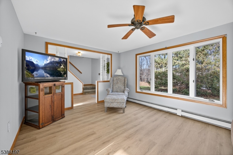 61 Coykendall Road Wantage, NJ 07461 - Photo 15 of 43 a living room with furniture and a flat screen tv with wooden floor