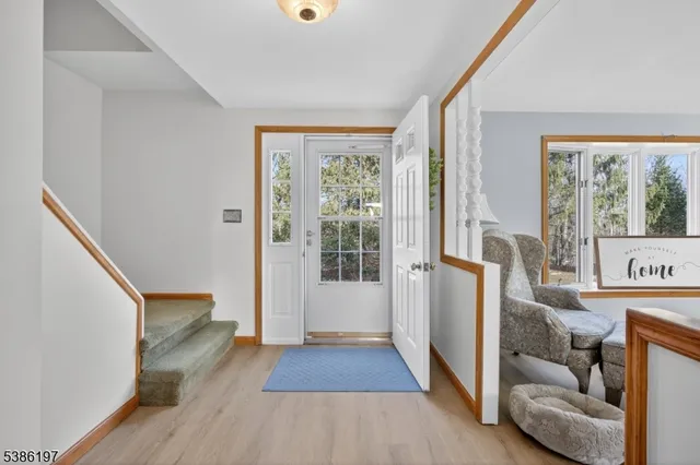 a view of a livingroom with wooden floor and furniture