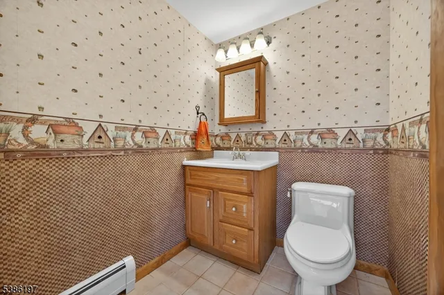 a bathroom with a toilet a sink and a mirror